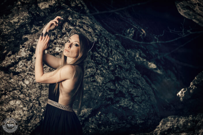 Floriane en robe noire dans une forêt rocheuse, photographie artistique par Julien Zannoni